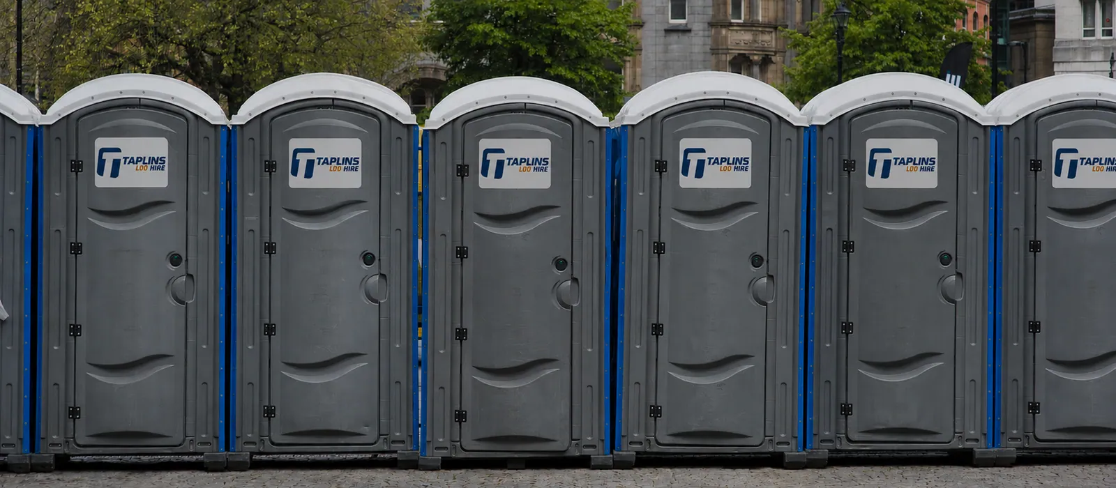 A row of Taplins portable toilets ready for an outdoor event